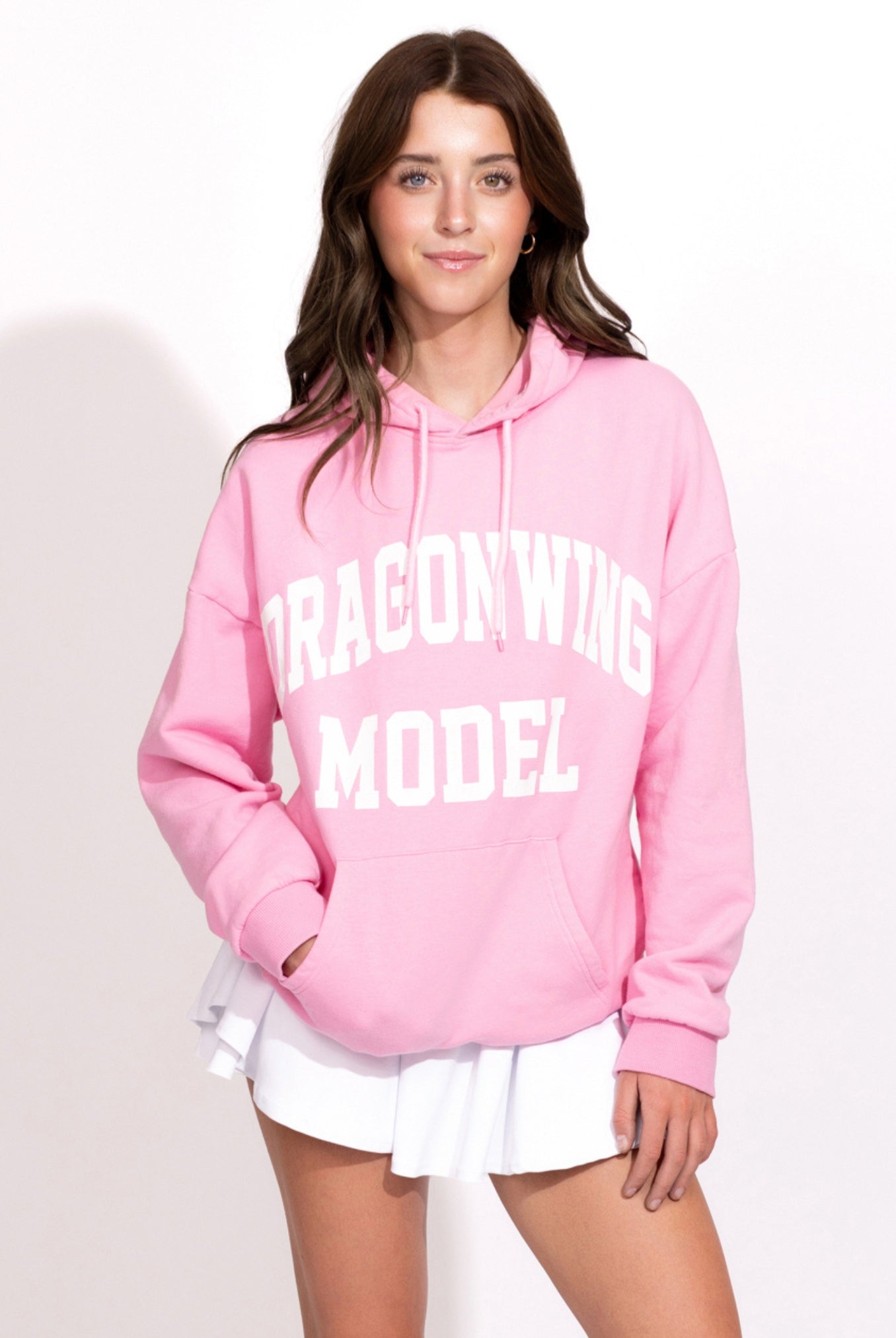 Person wearing a pink hoodie with 'Dragonwing Model' text on a white background
