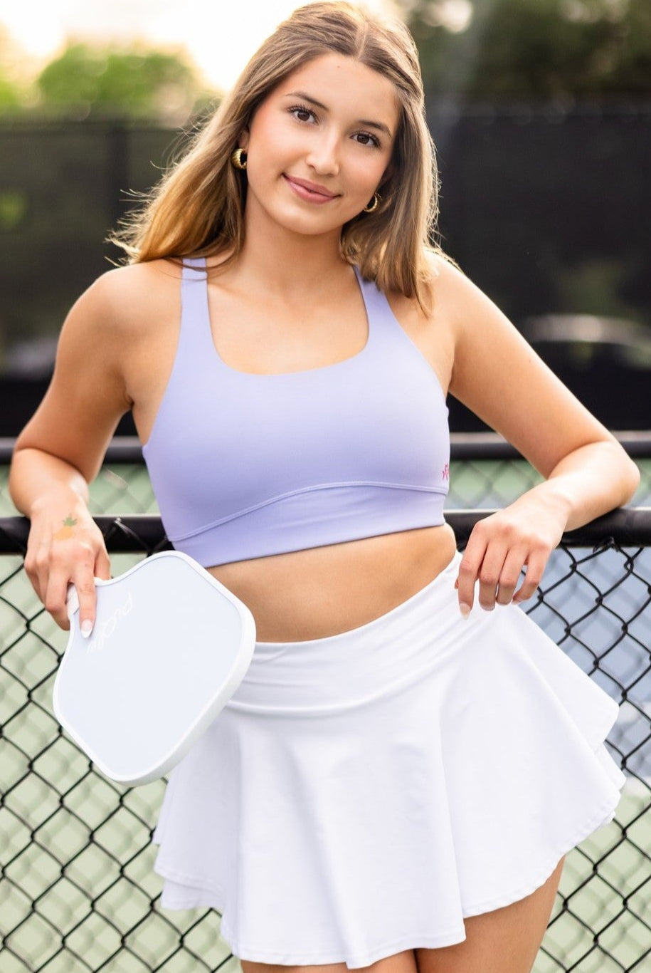 White girls tennis skirt styled for pickleball on outdoor court