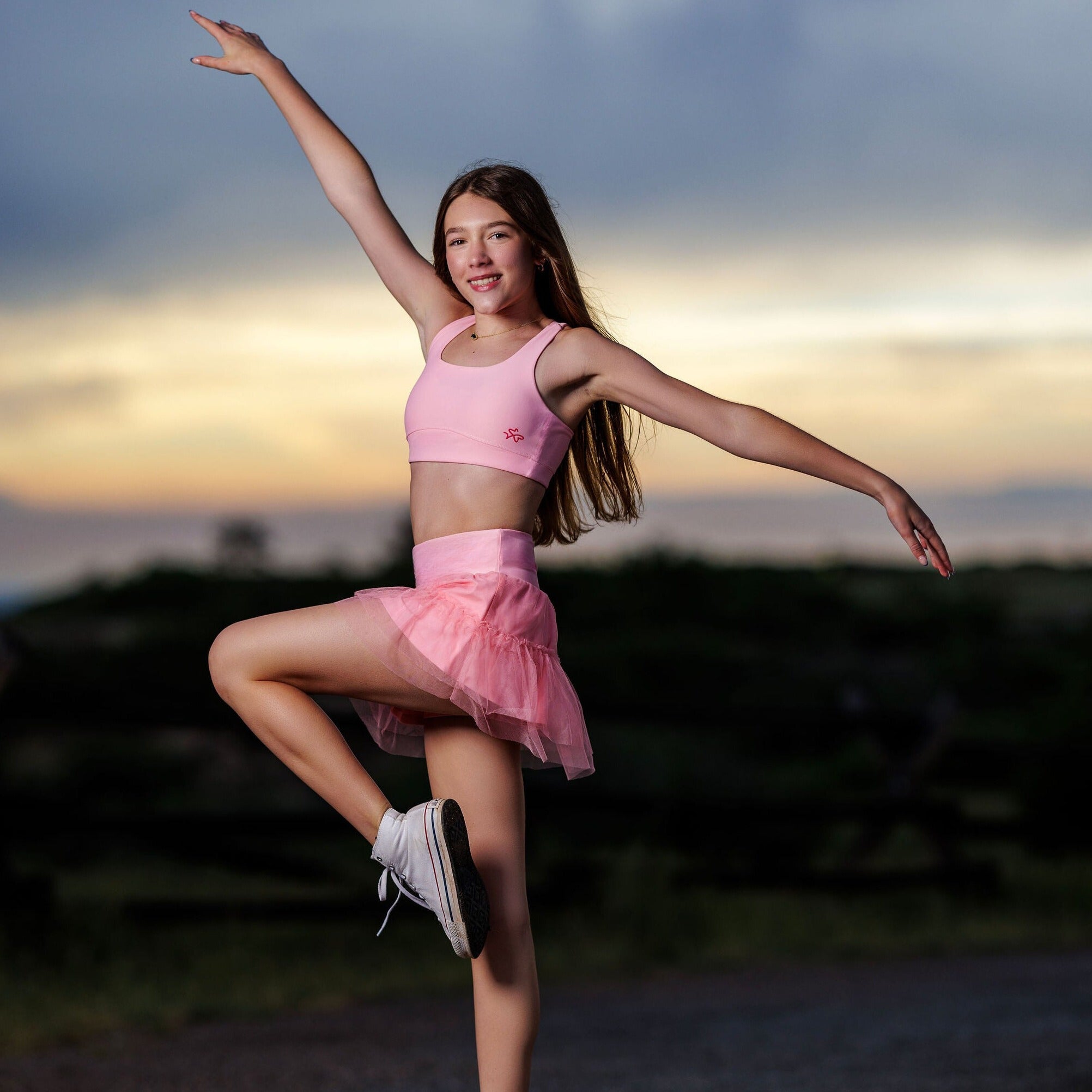 girls pink tennis skirt with built-in shorts in motion outdoors