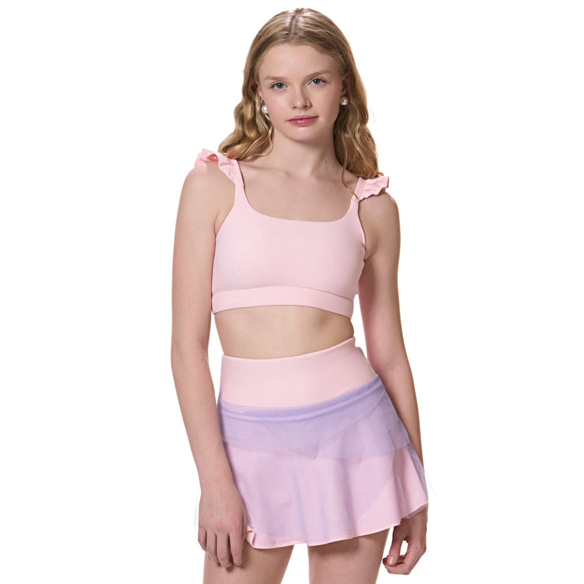 girl wearing flare tennis skirt with matching pink sports bra front view