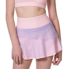 girl wearing pink and purple flare tennis skirt front view